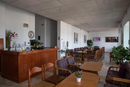 a dining room with tables and chairs and tablesktop at Sea Breeze Hotel in Mastichari