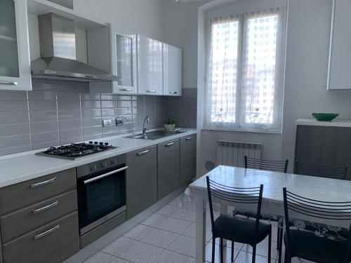 a kitchen with a stove and a table with chairs at MariMARE in Sestri Levante