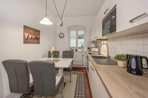 a kitchen with a table and some chairs and a sink at Villa Meereswoge 02 in Bansin