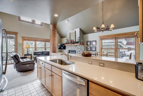 a kitchen with a sink and a living room at Cabin In The Pines 4 in Keystone