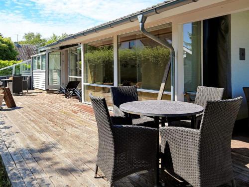 a patio with a table and chairs on a deck at Seaside Retreat in Havnso-By Traum in Føllenslev