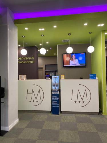 a lobby with two counters and a tv on a wall at Hotel Miramonti in Turin