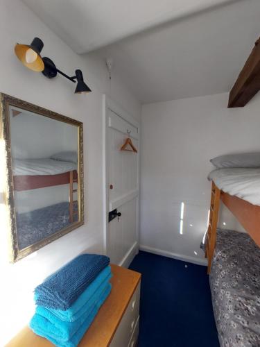 a bedroom with a mirror and a bunk bed at The Manor House, Curry Mallet in Taunton