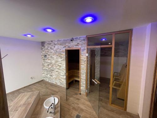 a bathroom with a sink and a stone wall at Nordic Avantage Hotel in Kiel