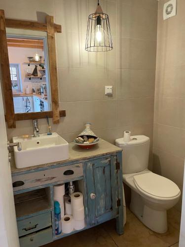 a bathroom with a sink and a toilet and a mirror at Casa Holi in Valada
