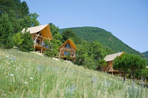a group of cottages on top of a hill at Village Huttopia Dieulefit in Dieulefit