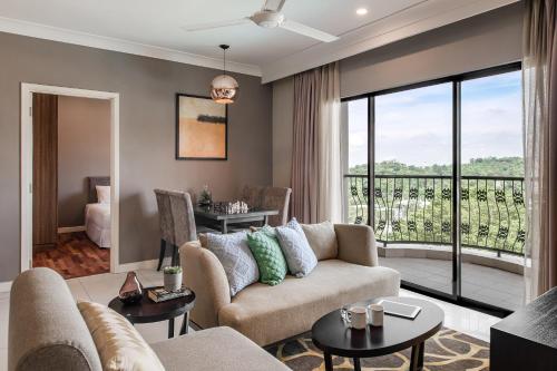 a living room with a couch and a balcony at Domitys Bangsar Kuala Lumpur in Kuala Lumpur