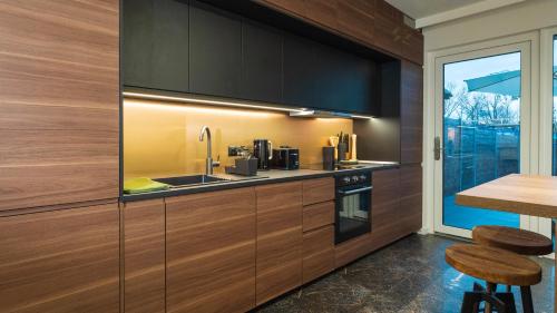 a kitchen with wooden cabinets and a sink at Work & Travel _ EcoStay _ Środa Wielkopolska in Środa Wielkopolska