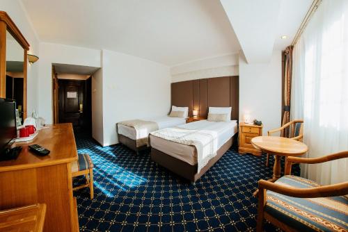 Кровать или кровати в номере Hotel Best Western Bucovina