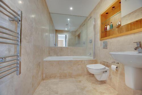 a bathroom with a toilet and a sink and a shower at Amazing City Centre Penthouse With Private Roof Terrace in Newcastle upon Tyne