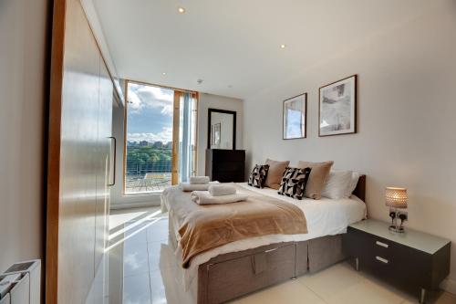 a bedroom with a bed and a large window at Amazing City Centre Penthouse With Private Roof Terrace in Newcastle upon Tyne