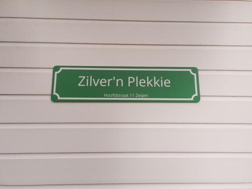 a green sign that reads zivenin pelketike on a wall at Zilver'n Plekkie in Zeyen