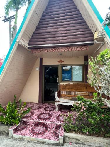 a house with a bench on the front porch at Seven-in in Ban Khlong Chi Lat