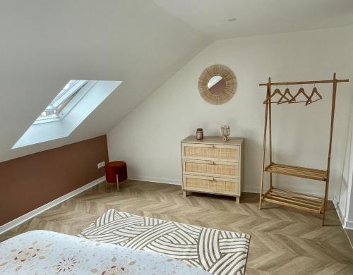 a bedroom with a bed and a dresser and a window at Appartement L’opale d’Anaé in Boulogne-sur-Mer