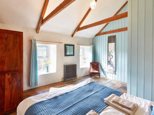 a bedroom with a bed and a blue rug at Glanceri in Sarnau