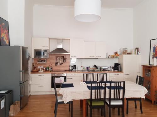 a kitchen with a table and chairs in it at be at home with Philip & Marie in Klagenfurt