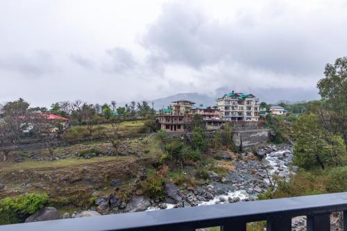 a view of a resort and a river at Kailasham Stay in Dharamshala