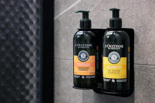 two bottles ofodorizers are sitting on a wall at Hotel Prokop Square in Prague