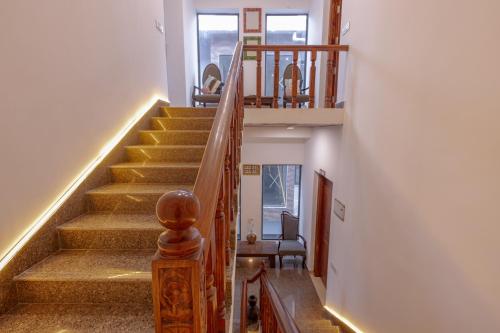a staircase in a home with a stair railing at Kailasham Stay in Dharamshala