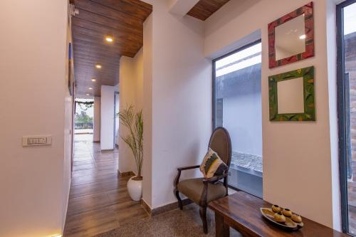 a hallway of a home with a table and a chair at Kailasham Stay in Dharamshala