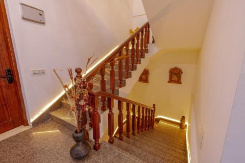 a hallway with stairs with a stair light on it at Kailasham Stay in Dharamshala