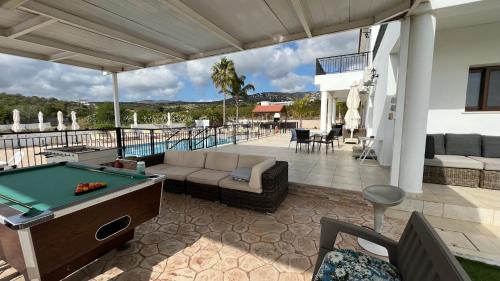 un tavolo da biliardo su un patio con tavolo da biliardo di Nayia Paradise Villa! Best Villa in Cyprus a Paphos