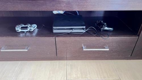 a wooden desk with a laptop and consoles on it at Nayia Paradise Villa! Best Villa in Cyprus in Paphos City
