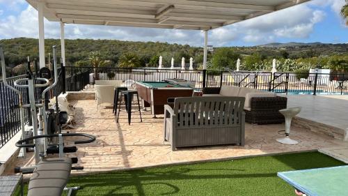 a patio with a ping pong table and a pool table at Nayia Paradise Villa! Best Villa in Cyprus in Paphos City