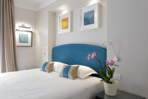 sypialnia z łóżkiem z niebieskim zagłówkiem w obiekcie La Villetta Suite w Ciampino