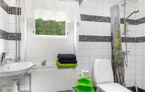 a white bathroom with a toilet and a sink at 1 Bedroom Stunning Home In Sala in Sala