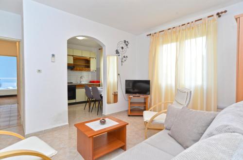 a living room with a couch and a table at Apartments Pietro 2228 in Bale