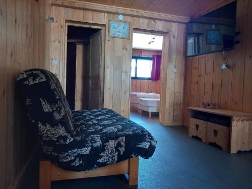 a room with a chair in a wooden room at Appartement Le Pic in Samoëns
