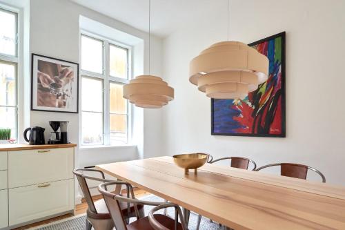 a dining room with a wooden table and chairs at Bright Apartment in the Old Town of Copenhagen in Copenhagen