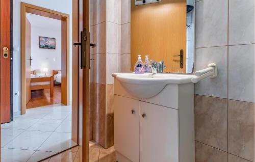 a bathroom with a sink and a mirror at Lovely Apartment In Medulin With Kitchen in Medulin