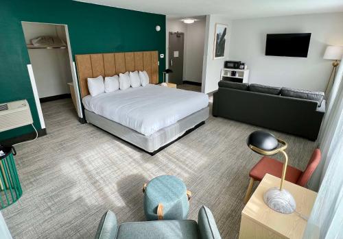 a hotel room with a bed and a couch at Best Western Portland West Beaverton in Portland