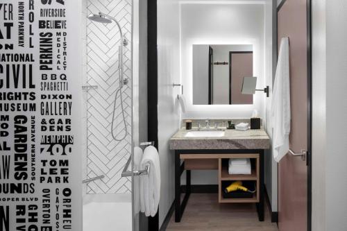 a bathroom with a sink and a mirror at Hyatt Centric Beale Street Memphis in Memphis