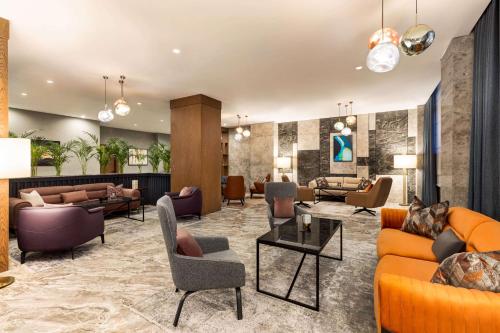 a lobby with couches and chairs at Wyndham Garden Baku in Baku