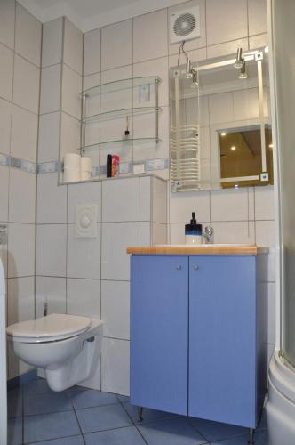 a bathroom with a sink and a toilet and a mirror at WROCLOVE_NET MUCHOBOR in Wrocław
