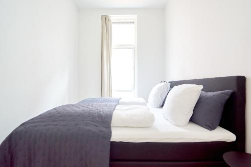 - une chambre avec un lit doté de draps blancs et une fenêtre dans l'établissement Great Apt · Near Beach · CPH, à Copenhague