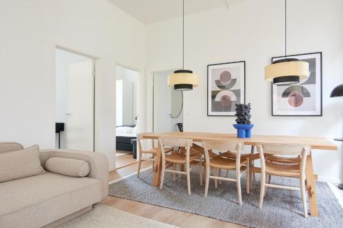 a living room with a dining room table and a couch at Great Apt · Near Beach · CPH in Copenhagen