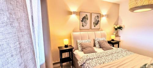 a small bedroom with a bed and two lamps at Home Andrea with infinity salty pool in Roč