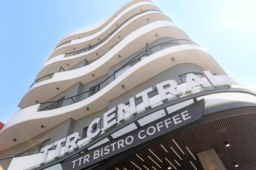 a building with a sign that reads the granarian the bestino coffee at TTR Central Apart Hotel in Da Lat