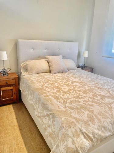 a bedroom with a large bed with two pillows on it at Benicasim Primera Linea Vistas al Mar in Benicàssim