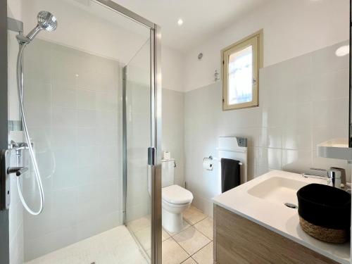 a bathroom with a shower and a toilet and a sink at Domaine de Licetto in Bonifacio