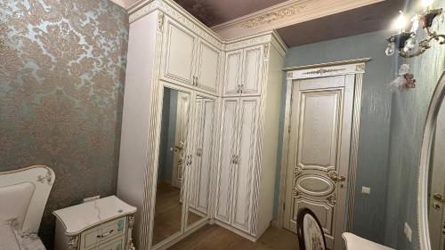 a bathroom with a toilet and a white cabinet at Downtown Luxury furnished apartment in Yerevan