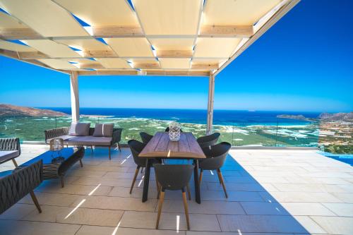 a dining room with a view of the ocean at Nafsika Xenia - Ariti Villa in Plátanos