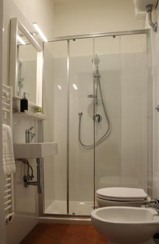 a bathroom with a shower with a toilet and a sink at Friends of Michelangelo in Florence