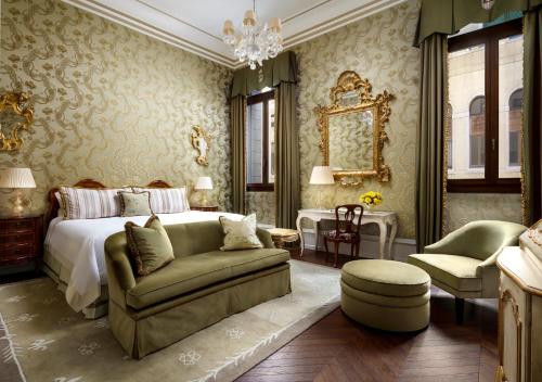 a bedroom with a bed and a couch and a chair at The Gritti Palace, a Luxury Collection Hotel, Venice in Venice