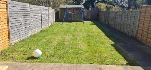 a yard with a playground with a blue swing at Spacious Swanky Home 4 Groups & Contractors near NEC & Airport in Olton