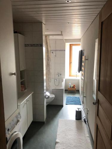 a bathroom with a tub and a toilet and a sink at Charisma Peist Act-Sports Arosa in Peist